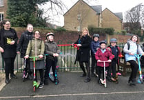 Children ride scooters to breakfast club