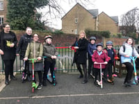Children ride scooters to breakfast club