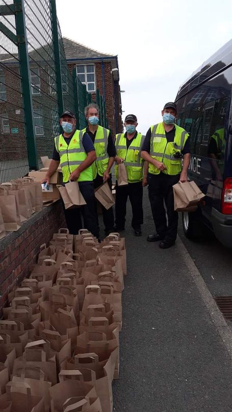 Civil Defence members handing out lateral flow devices at Ballakermeen High School during the pandemic