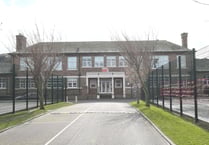 Youths smash school window