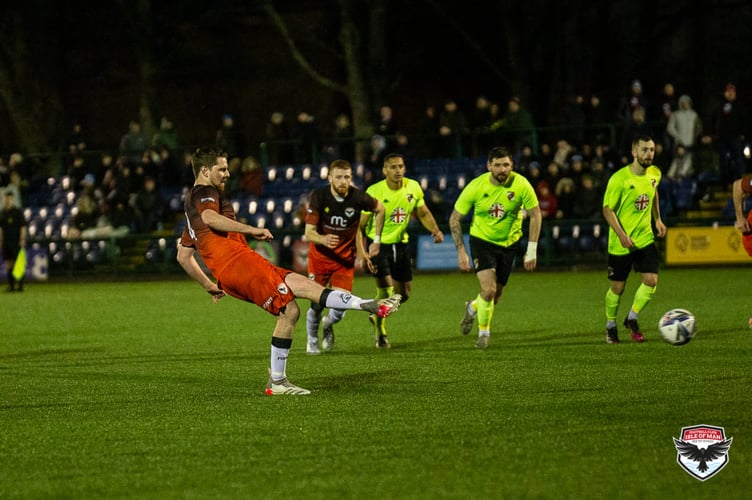 FC Isle of Man’s Jack McVey slots home from the penalty spot in Saturday evening’s 1-1 draw with Abbey Hey