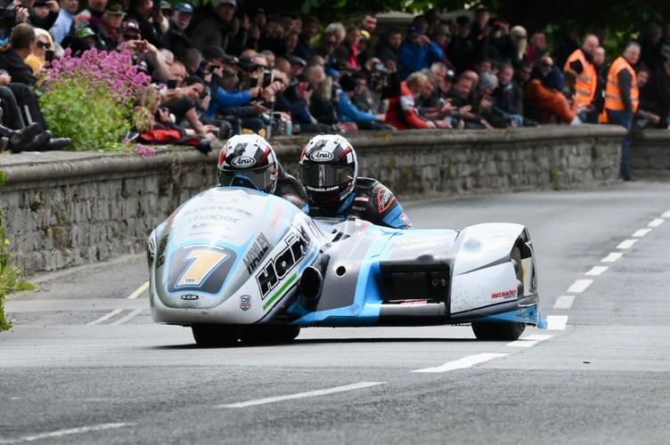 The Birchall brothers on their way to victory in the first sidecar race of the week