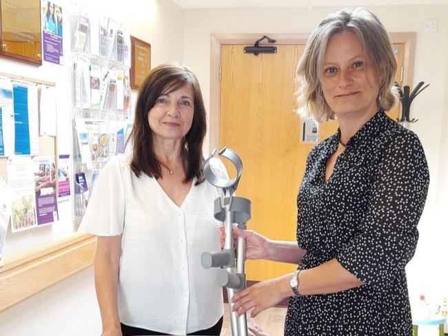 Hilary Yates (Western Wellbeing Partnership Referral coordinator) and Claire Bader (Western Wellbeing Partnership lead) with a pair of crutches that have been handed in at the Western Wellbeing Centre in Peel