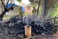 Unattended bonfire causes log store to catch fire