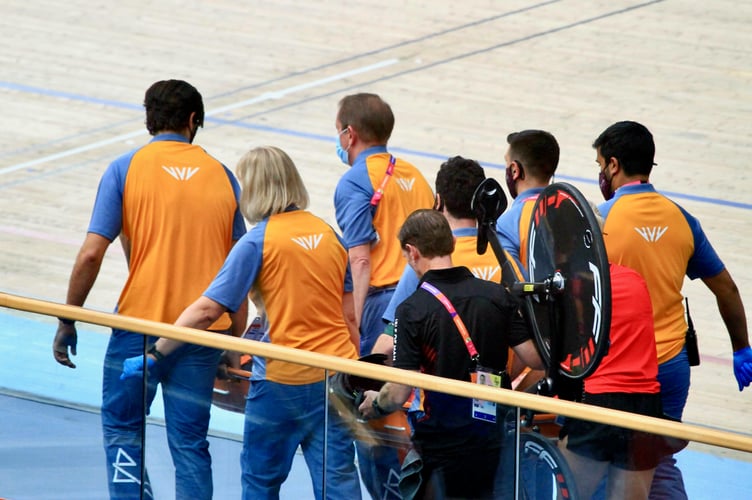 Matt Bostock is stretchered away from the track after being hurt in a serious crash in the men’s 15km scratch race qualifying at the 2022 Commonwealth Games. Cycling team manager Andrew Roche can be seen carrying Bocky’s bike