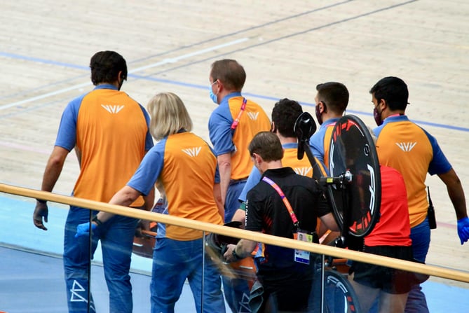 Matt Bostock is stretchered away from the track after being hurt in a serious crash in the men’s 15km scratch race qualifying at the 2022 Commonwealth Games. Cycling team manager Andrew Roche can be seen carrying Bocky’s bike