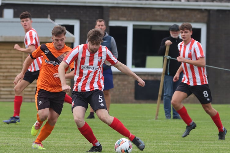 Ayre Utd’s Declan Cummins (left) and Peel’s Sam Kennaugh in action during last weekend’s Canada Life Premier League clash in Andreas