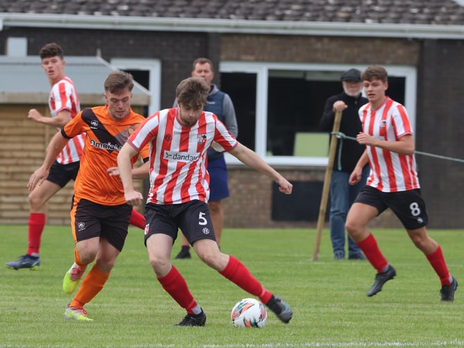 Ayre Utd’s Declan Cummins (left) and Peel’s Sam Kennaugh in action during last weekend’s Canada Life Premier League clash in Andreas
