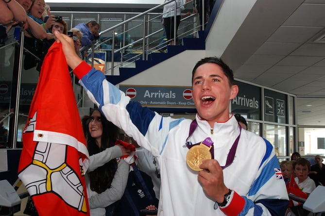 Peter Kennaugh arrives Ronaldsway with Olympic Gold.