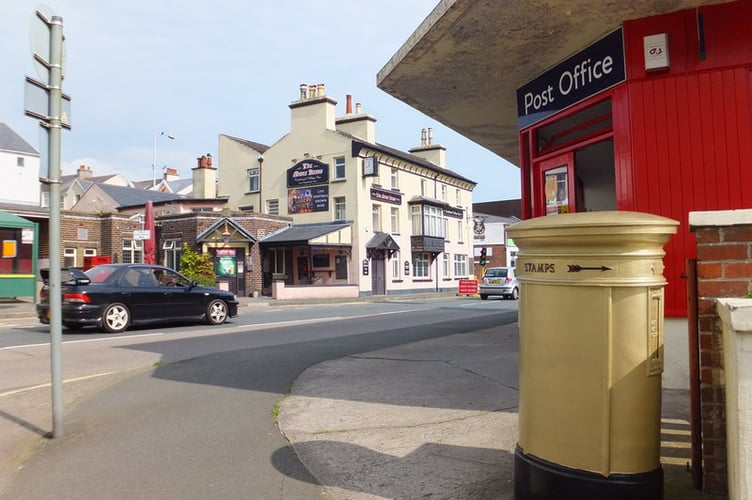 Golden post box in Onchan