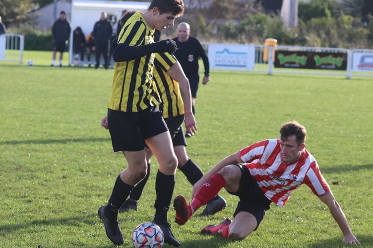 Peel’s Rhys Oates challenges Rushen Utd’s Christos Loizides during Saturday’s Old Firm clash in Port Erin (Photo: Paul Hatton)