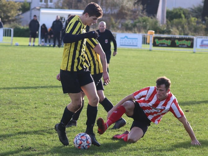 Peel’s Rhys Oates challenges Rushen Utd’s Christos Loizides during Saturday’s Old Firm clash in Port Erin (Photo: Paul Hatton)