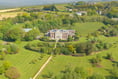 This mock-Georgian mansion comes with its own tennis court and library