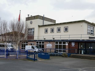 Treasury Minister committed to school plan despite its absence in book