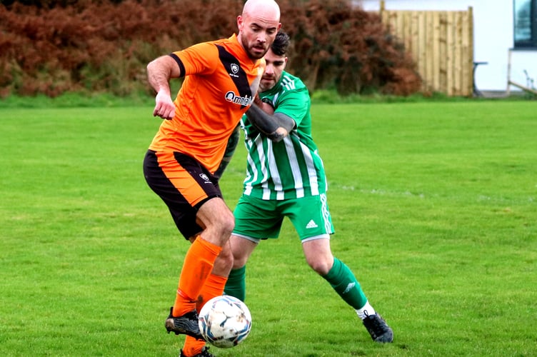 Ayre Utd's johnny Shields (left) and Michael Utd's Brendan Harrison in action during Saturday's ECAP FA Cup clash at Balleira Road