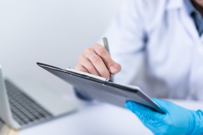 Stock image of GP making notes