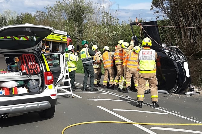 Fire crews dealing with an overturned car on Whitebridge Road in Onchan