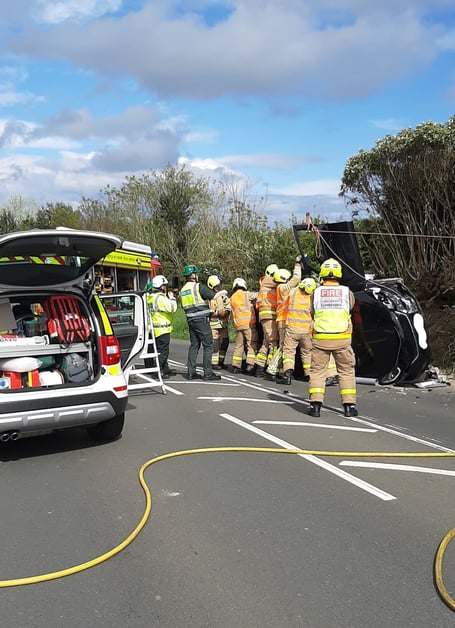 Fire crews dealing with an overturned car on Whitebridge Road in Onchan