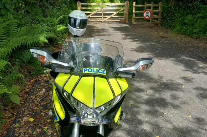 Police bike in front of wooden gate