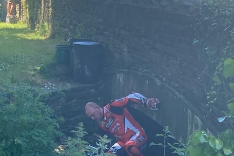 Peter Hickman climbing through the drainage tunnel at Greeba