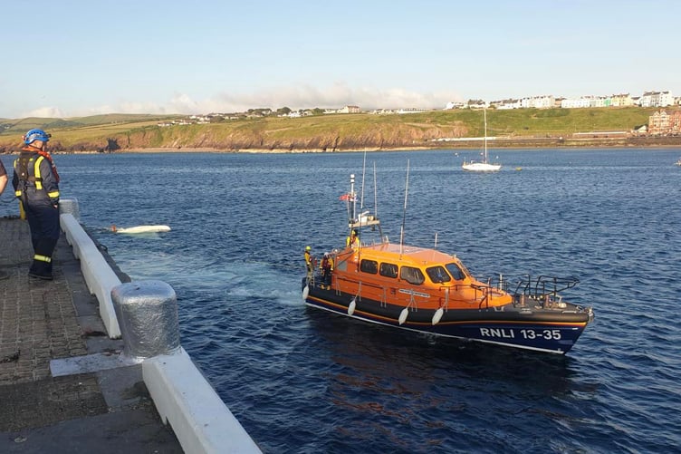 Peel Lifeboat ‘Frank and Brenda Winter’ tows the capsized dinghy back into Peel Bay