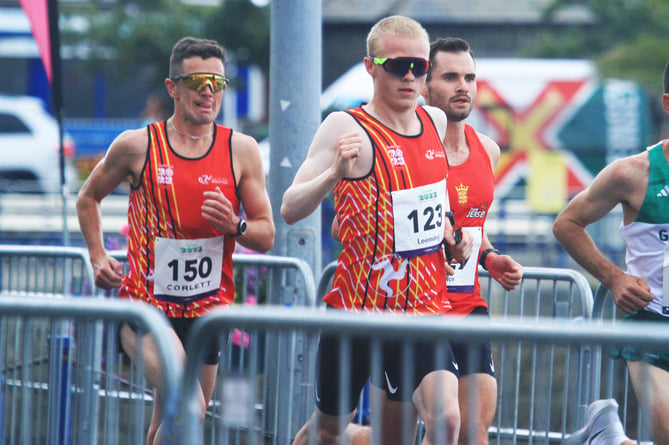 Corrin Leeming (centre) on his way top victory in the men's half-marathon, with team-mate Alan Corlett in hot pursuit