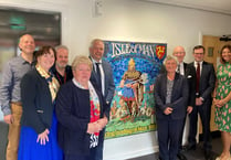Governor unveils mosaic on tour of postal headquarters