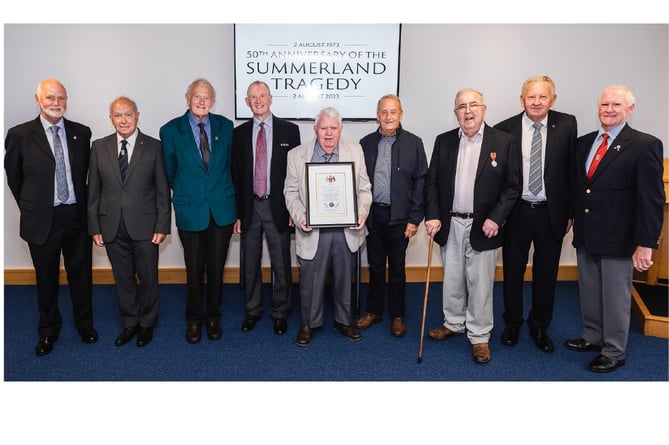 Retired firefighters who were present at the Summerland fire and during the following days attended Monday’s event. The Isle of Man Fire and Rescue Service’s Scroll of Recognition is held by Godfrey Cain, who was on the second engine to reach the scene