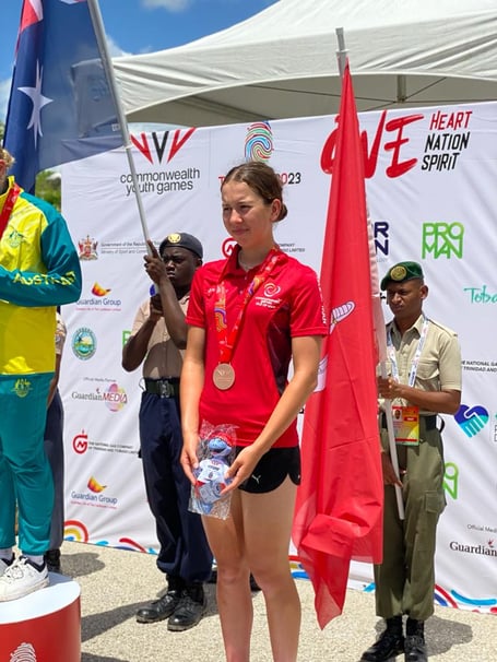 Ruby Oakes on the podium with her bronze medal
