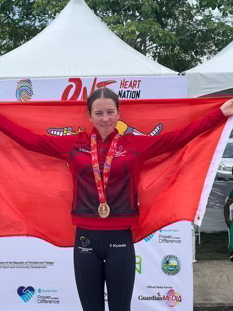 Ruby Oakes flies the Manx flag on the podium with her bronze medal