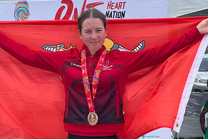 Ruby Oakes flies the Manx flag on the podium with her bronze medal