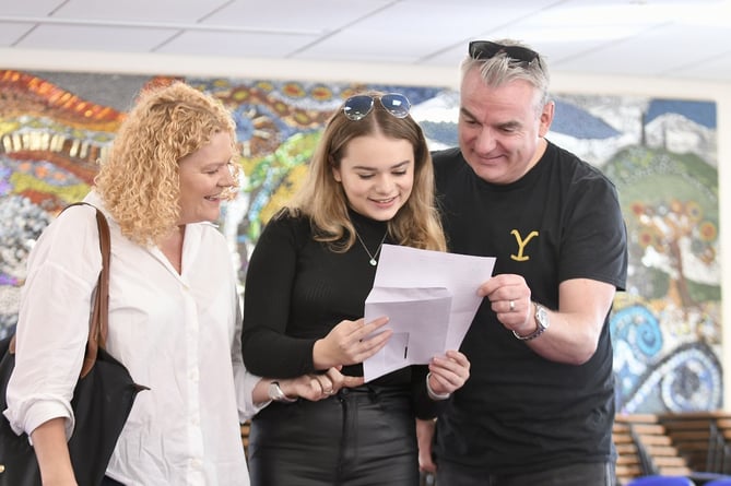 Daisy Goodby reading her GCSE results with her parents