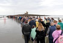 Hundreds walk out to the Tower of Refuge