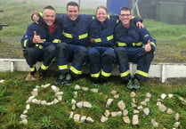 Firefighters finish charity challenge with epic 'full fire kit' finale
