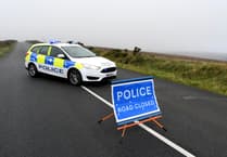 Isle of Man road to stay closed until people 'actively avoiding police' are found