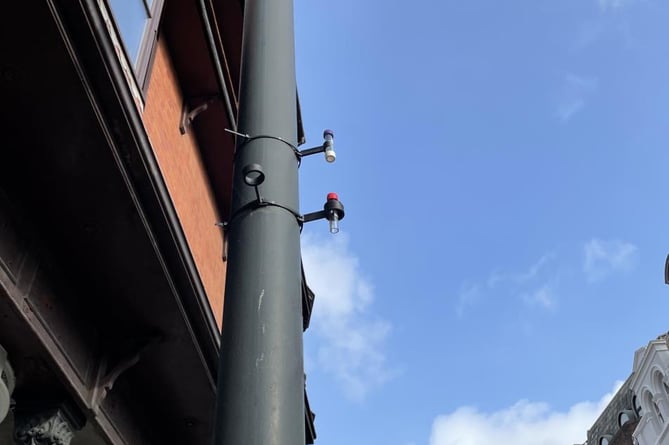 A diffusion tube installed on a lamppost to measure air quality
