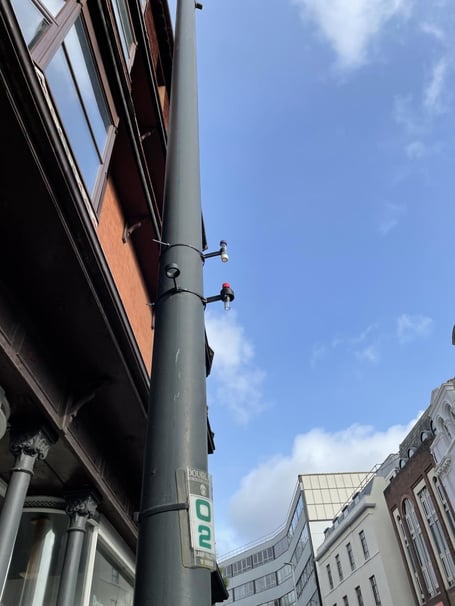 A diffusion tube installed on a lamppost to measure air quality