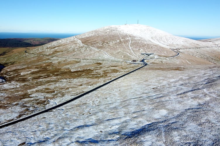 Snow on Snaefell and the A18 mountain road -