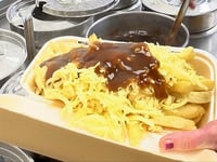Watch as chippy serves up perfect portion of chips, cheese and gravy