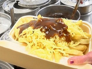 Watch as chippy serves up perfect portion of chips, cheese and gravy