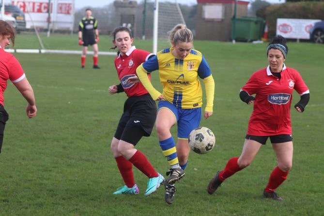 Onchan's Ruby Palmer is closely watched by Castletown MFc's Cushlin Humphries (left) and Tracey Wilson (right)