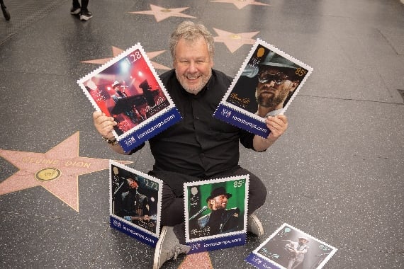 Photographer Guido Karp with the stamps at the Bee Gees star