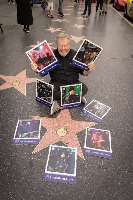 Photographer Guido Karp with the stamps at the Bee Gees star