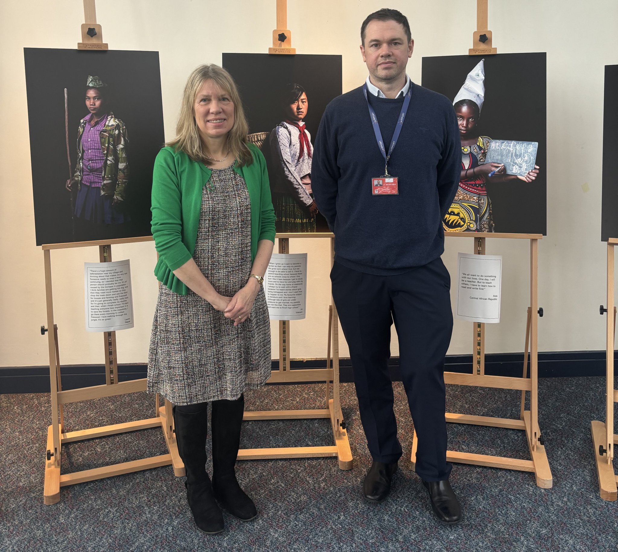 Wendy Shimmin from the One World Centre and airport director Gary Cobb with images from the exhibition