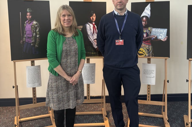 Wendy Shimmin from the One World Centre and airport director Gary Cobb with images from the exhibition