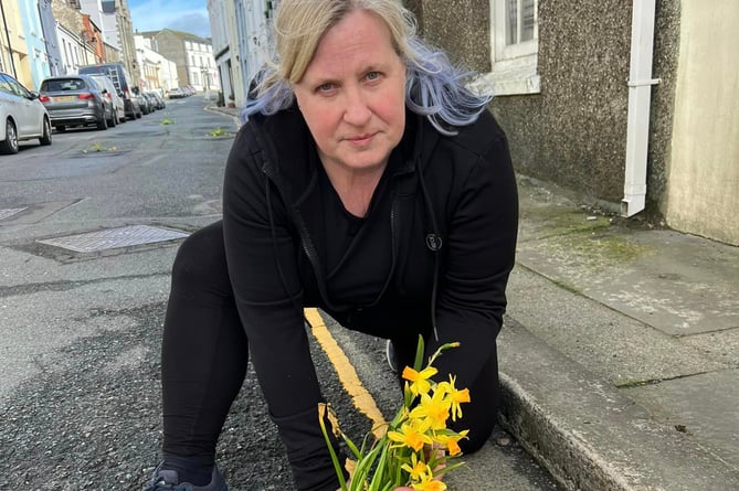 Michelle Haywood fulfilled her promise to plant daffodils in potholes on a main road in the south of the island 