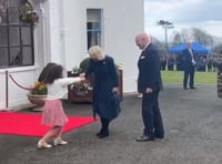 Watch the moment Queen Camilla is presented with flowers by schoolgirl
