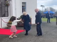 Watch the moment Queen Camilla is presented with flowers by schoolgirl