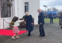 Watch the moment Queen Camilla is presented with flowers by schoolgirl