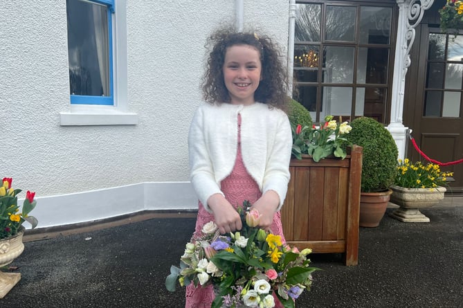 Saskia Edge, age 10, from Onchan presented flowers to Her Majesty when she arrived
